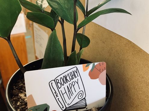 Photo of gift card displayed in a potted plant
